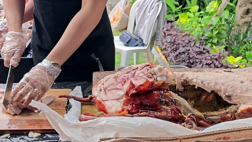 Chef Slicing Traditional Balinese Roasted Suckling Pig (Babi Guling) for Serving