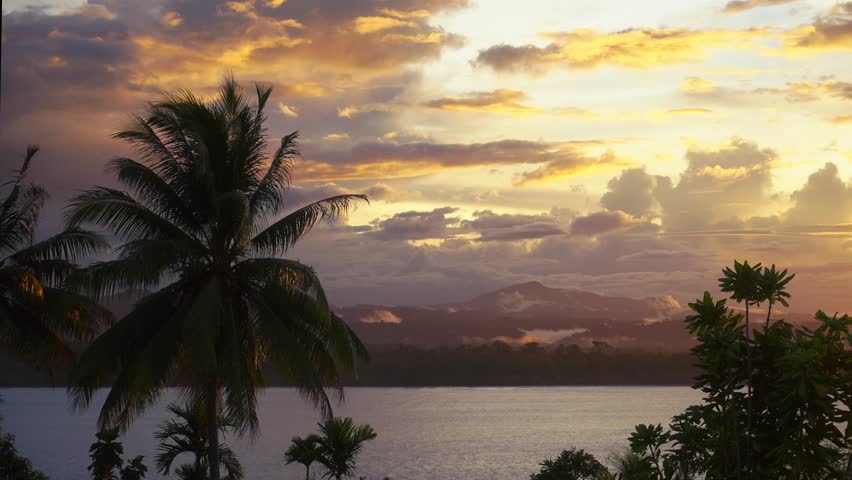 Wewak Hill vibrant sunset Cape Wom Public Beach Wewak Papua New Guinea PNG Papua Niugini Boutique Hotel landscape panoramic view East Sepik Province landscape breeze palm trees rainy season clouds fog