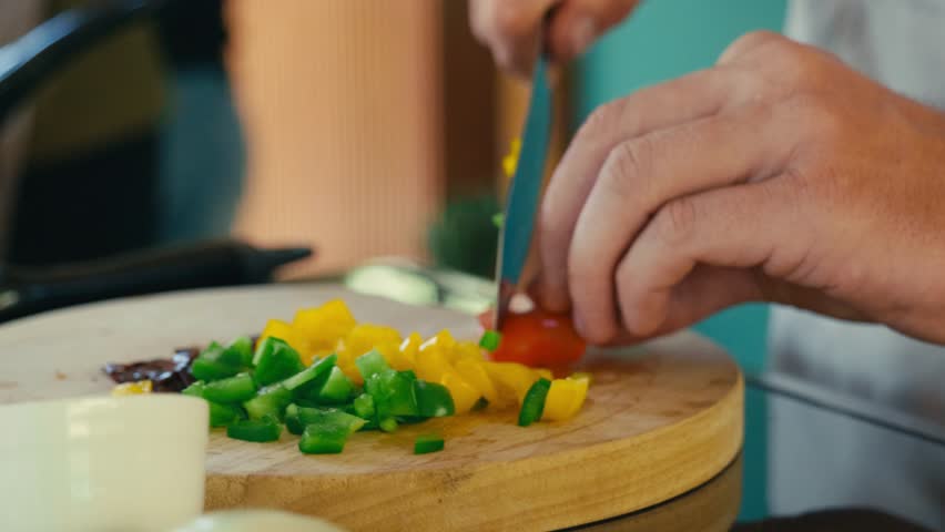 A Thai chef cutting fresh herbs and vegetables while preparing ingredients for traditional Thai cooking, showcasing knife skills and authentic food preparation.
