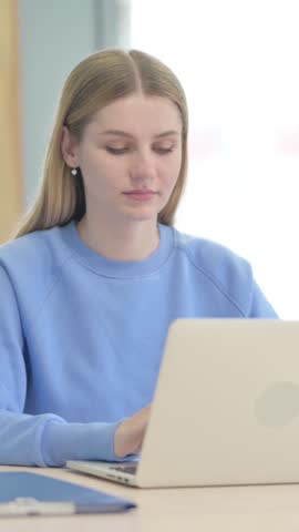 Young Woman Working on Laptop at Work