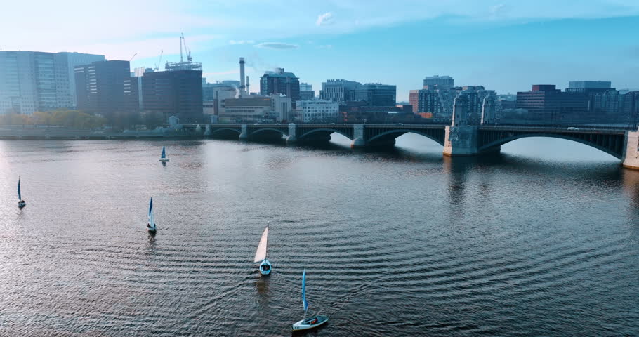 Approaching the Longfellow Bridge with cars driving on. Sailboats are on the Charles River in Boston, Massachusetts, USA.