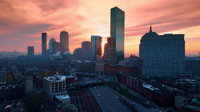 Downtown of modern Boston, Massachusetts, USA. Aerial perspective of the lively city at sunset time.