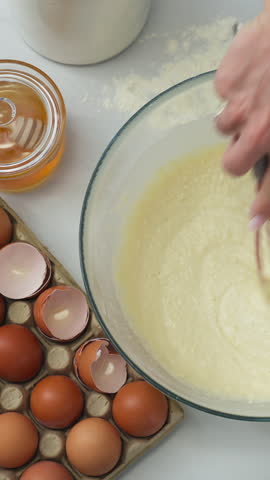 Vertical View Of A Hand Whisking Pancake Batter. Overhead Shot