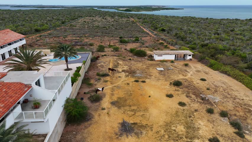 Drone view of El Yaque, Venezuela with desert, sea, and a distant hotel