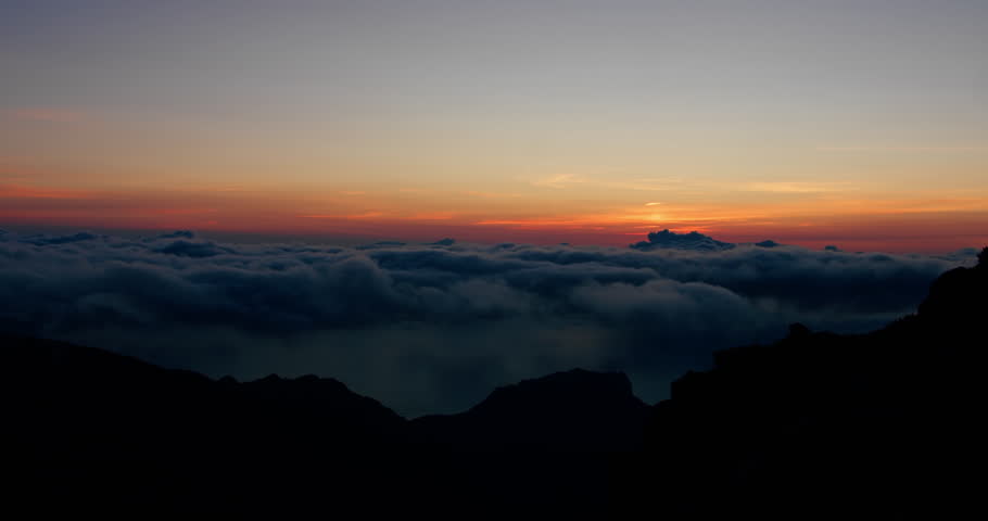 Sunrise above cloud layer from mountain viewpoint on Madeira Island, timelapse of sun emerging