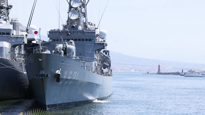 Battleship docked in Naples Harbor, Italy, showcasing naval military vessels, maritime infrastructure, and coastal scenery for travel and defense visuals.