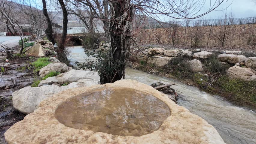 Filmed this river with a rock in front of it, carved with a circle, and it