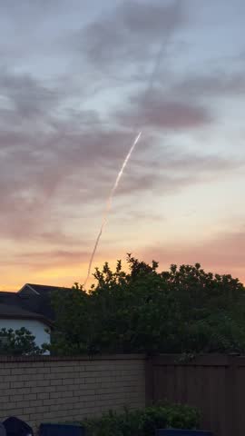 Exhaust trail from a SpaceX rocket launch in Florida at sunset.