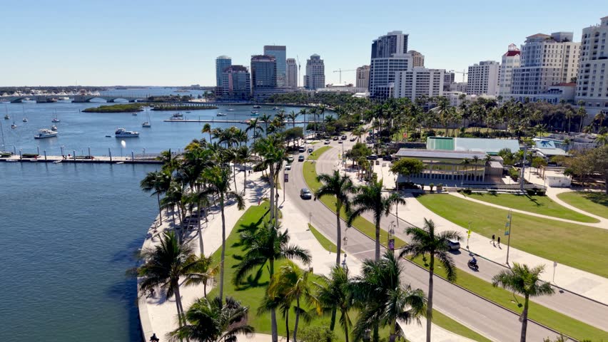 palms line the streets pushing into the skyline of west palm beach florida