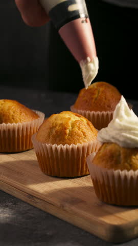 Vertical Of Cupcakes Topped With Whipped Cream Frosting. Close-up Shot