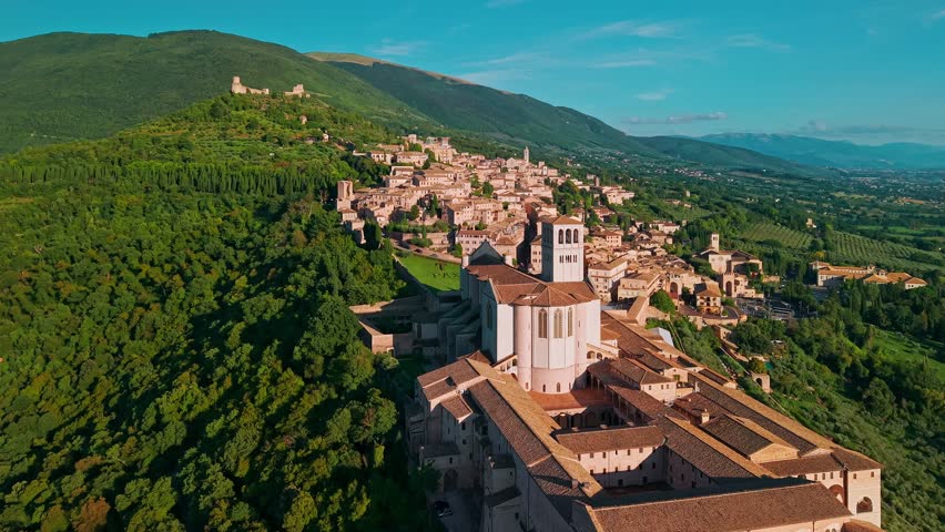 Aerial view of Assisi, Umbria, Italy. Highlights the Basilica of Saint Francis, this UNESCO World Heritage Site is a major Catholic pilgrimage destination and a masterpiece of medieval architecture.