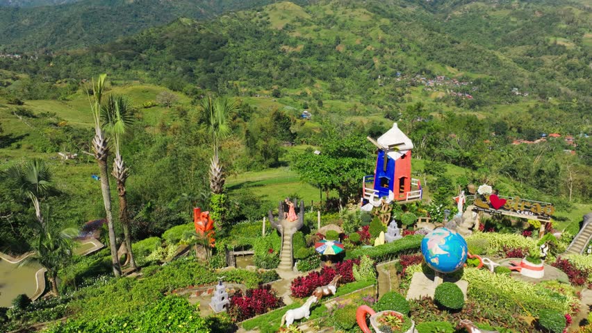 Man in black, woman in red dress, lush hillside garden November, Philippines