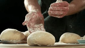 Super Slow Motion of a Baker Clapping His Hands and Throwing Flour Around. Filmed on High Speed Cinema Camera, 1000 fps. Closeup of Dough Preparation. - Powered by Shutterstock - Get 15% off with code: PIKWIZARD15