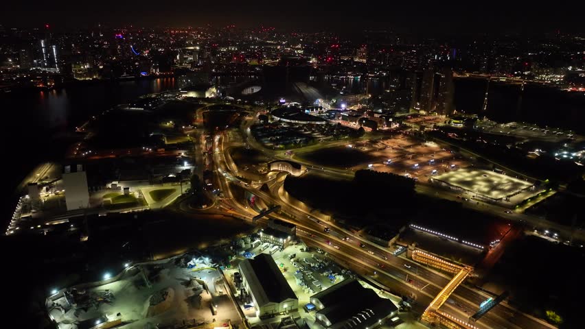 Aerial drone cinematic night video of iconic illuminated concert Hall of O2 Arena in North Greenwich Peninsula, London, United Kingdom