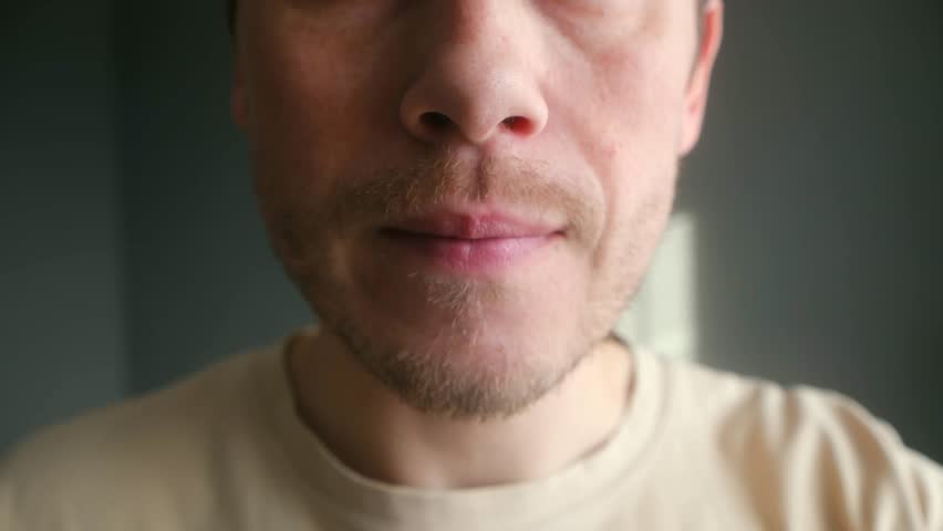 Caucasian man eating delicious japanese food with his hand. Close up capturing enjoyment tasting fresh sushi roll, showcasing appetite, savoring moment. Man eating sushi roll close up with pleasure