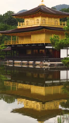Kinkaku-ji temple golden pavilion, Golden Pavillon garden in Kyoto, Rokuon-ji zen buddhist temple, Japan, Kita-ku Kita ward, autumn fall view, with reflection in a pond, travel to Japan