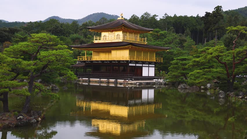 Kinkaku-ji temple golden pavilion, Golden Pavillon garden in Kyoto, Rokuon-ji zen buddhist temple, Japan, Kita-ku Kita ward, autumn fall view, with reflection in a pond, travel to Japan