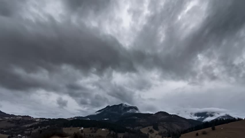 Dramatic Grey Clouds Moving Fast Over Mountain Countryside in Early Spring, Timelapse