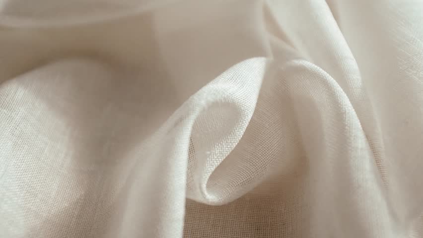 High-quality white loose texture cotton or linen fabric with a natural woven pattern. This clean, minimalist textile background features soft lighting, highlighting the organic fibers and intricate weave of the cloth. Ideal for themes of sustainable fashion, luxury bedding, home decor, and organic lifestyle.