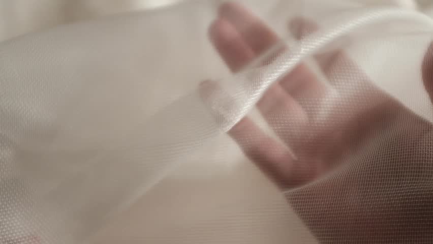 High-quality white loose texture cotton or linen fabric with a natural woven pattern. This clean, minimalist textile background features soft lighting, highlighting the organic fibers and intricate weave of the cloth. Ideal for themes of sustainable fashion, luxury bedding, home decor, and organic lifestyle.