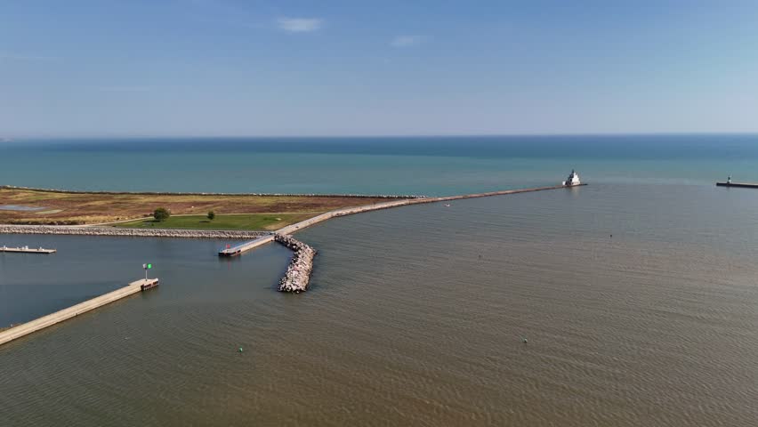 Aerials of Manitowoc Wisconsin USA on bright early fall day. Drone approach shot of breakwater and Lake Michigan.  