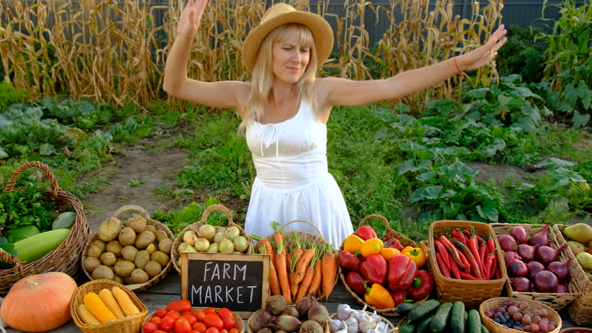 Woman at a farmers market with vegetables. Selective focus.