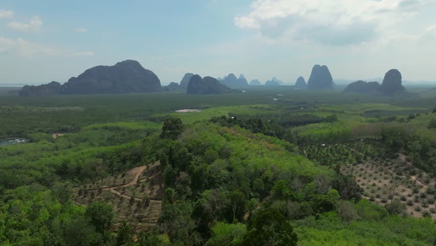 Aerial view of lush hills and dramatic rock formations in Thailands landscape