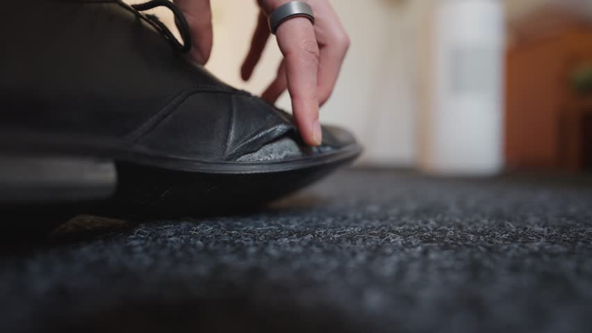 Close-up of a broken shoe. Cracked leather from worn material and poor-quality cheap footwear.
