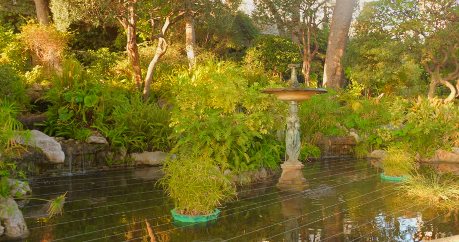Serene St Martin Gardens in Monaco City with lush greenery and statue