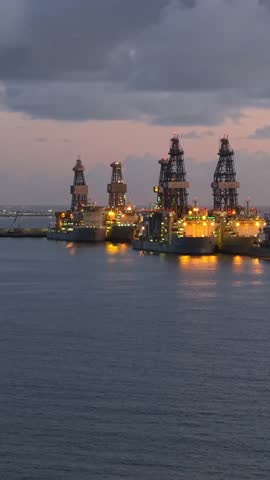 Aerial view of offshore drilling rigs moored at the industrial harbor of Las Palmas at twilight