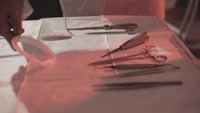Medical Instruments Arranged Carefully. Tray Holds Sterilized Medical Tools Beneath Red Operating Light - Powered by Shutterstock - Get 15% off with code: PIKWIZARD15