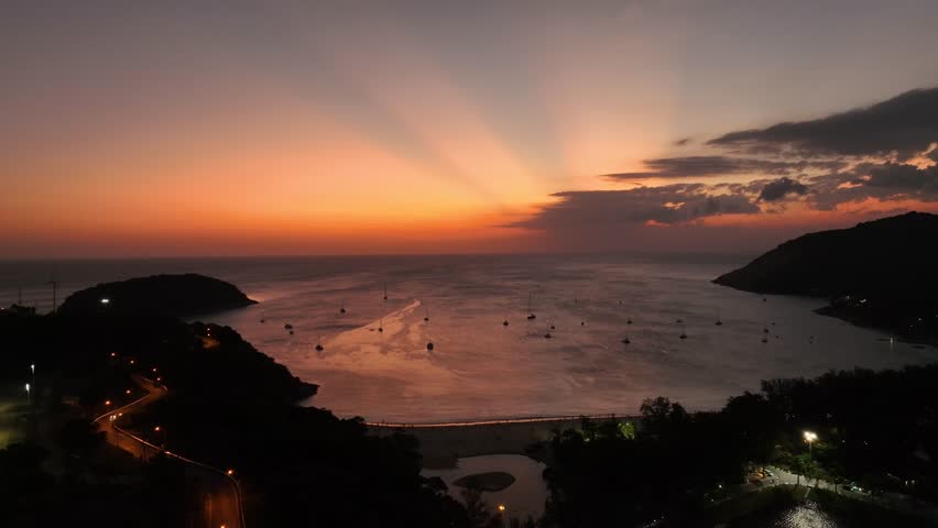 Aerial view of sunset over boats in the waters of Thailand