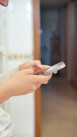 A woman is holding a cell phone and texting. Concept of modern technology and communication