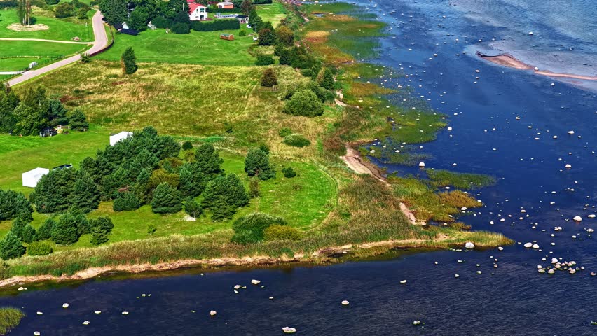 Aerial Drone View of Rural Shoreline with Blue Waters and Green Fields