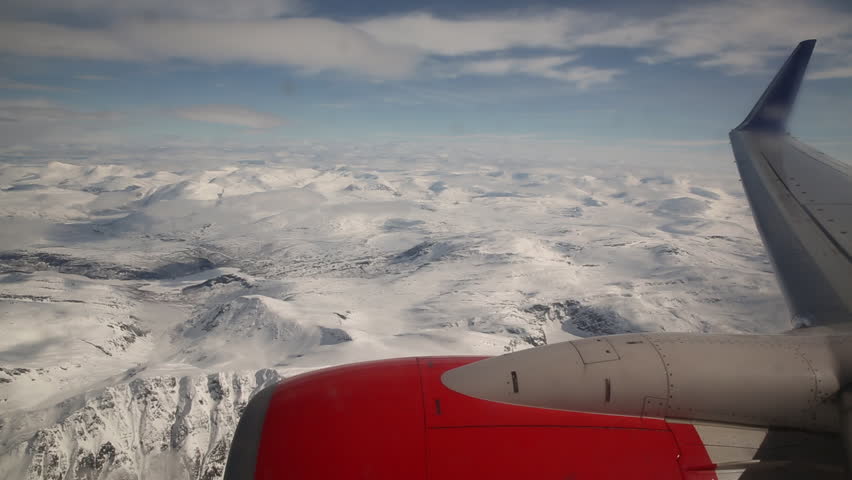 Airplane window view mountain winter landscape