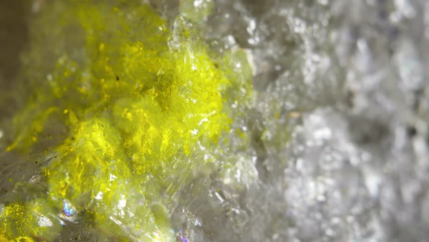The surface of a sea quartz crystal at high magnification. A mica stone in soft focus.