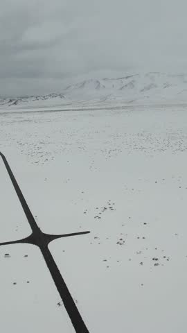 Journey Across Icy Mountain Plateau. Exploring Frosted Elevated Plains With Scenic Mountain Views Ahead. Venturing Over Snow Covered Plateaus Towards Majestic Summits Beyond Horizon