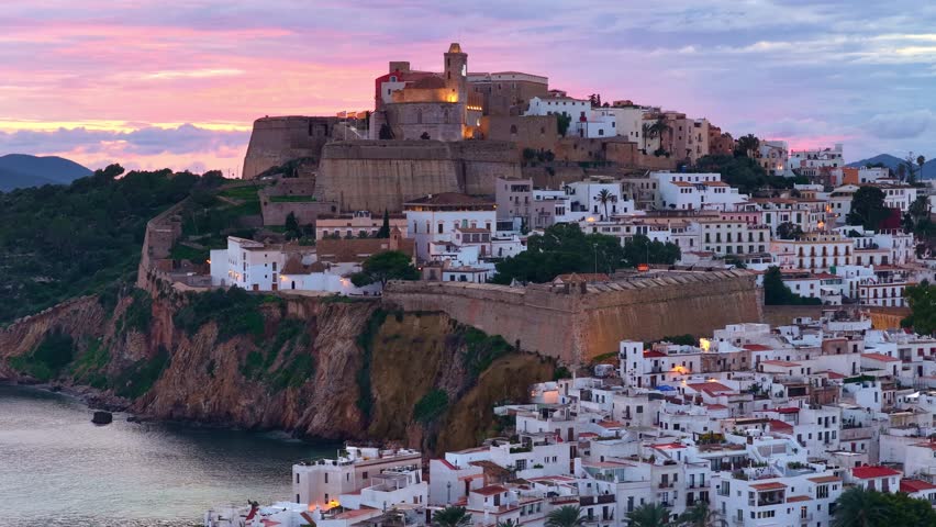 Sunset drone view of Eivissa castle in Ibiza, orbiting aerial view of the Almudaina historic old town, tourism on Ibiza island, Spain