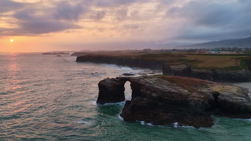 Sunrise at Cathedrals beach in Cantabria, Spain, aerial view of playa de las Catedrales on Spanish Atlantic coast, tourist destination in northern Spain
