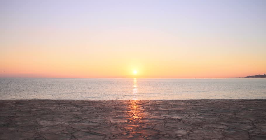 Fit happy woman jumping rope at the beach. Young female jumping against sea and sky background. Summer sport and healthy lifestyle concept. Slow motion