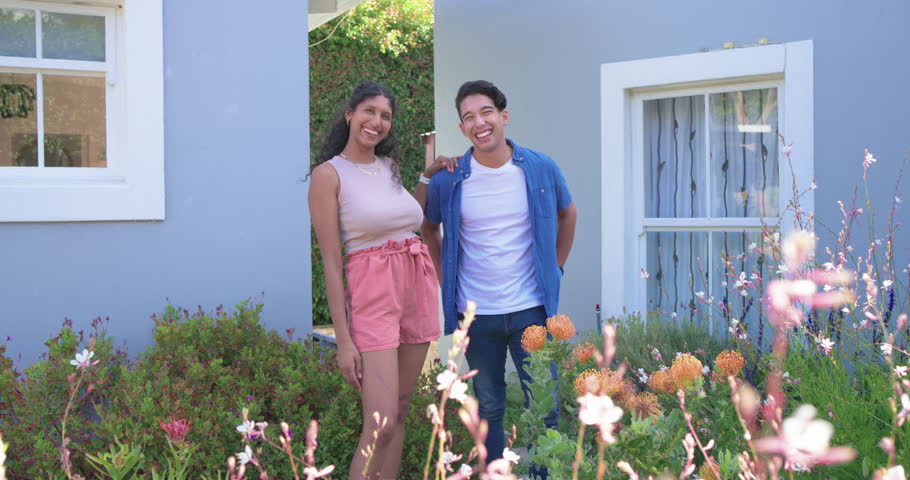 African American couple standing at front entry, woman resting hand, sharing laughs, flowers. Duo, warmth, garden, home, daylight, casual, affection
