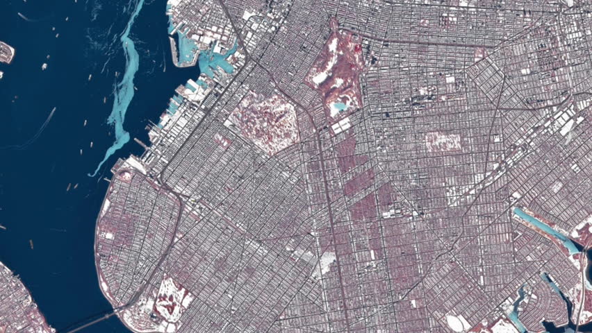 New York City winter conditions visible in satellite imagery showing ice along the Hudson River, snow-covered urban landscapes, and long seasonal shadows across the metropolitan area, based on data from NASA.
