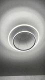 Close-up video of modern circular chandelier with LED lighting around the ring and side edges. Contemporary ceiling light glowing in dark room. Stylish interior lighting concept, minimal design. - Powered by Shutterstock - Get 15% off with code: PIKWIZARD15