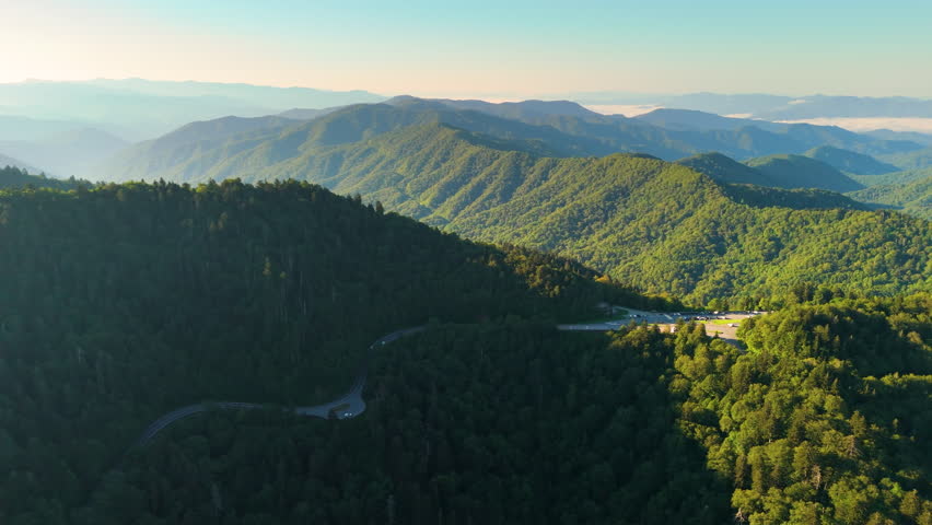 Car parking area for hikers and travelers at Newfound Gap overlook in Appalachian Mountains in summer. Mountain pass along the border of Tennessee and North Carolina.