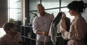 Creative minds engage in fashion design, measuring and discussing a new clothing piece in a stylish studio environment - Powered by Shutterstock - Get 15% off with code: PIKWIZARD15