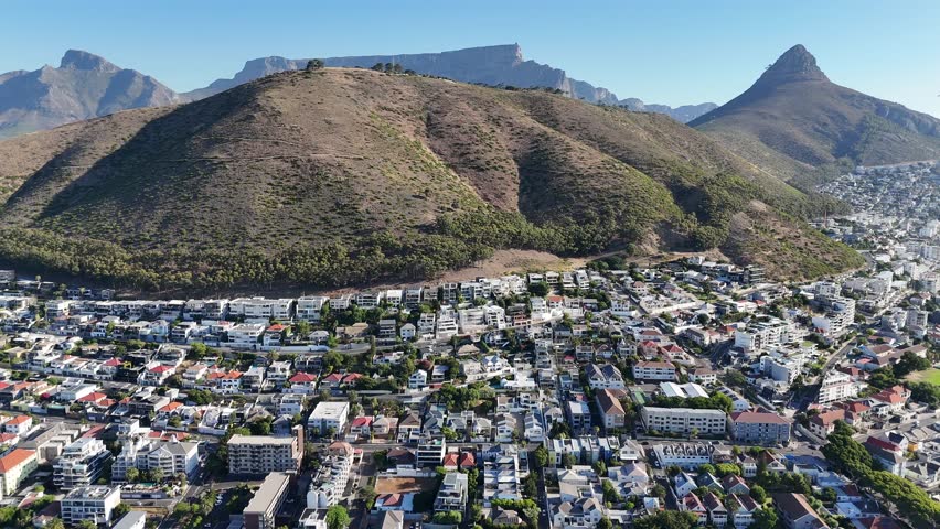 Drone flies high over Green Point toward Signal Hill with view of Lion