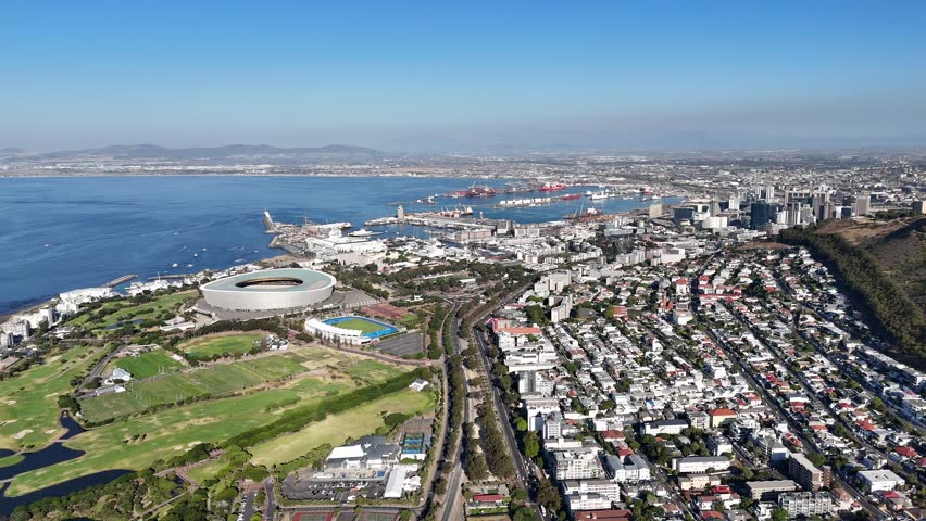 Drone facing north, orbits to the left high over Sea Point on a sunny day near Green Point, Cape Town, South Africa