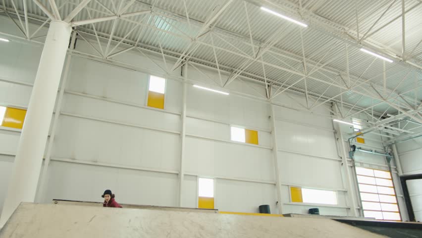 Young skater performing trick, skateboarder training in skatepark, making tricks, slides and flips, jump over the gap, professional extreme sport athlete ride on skateboard. 