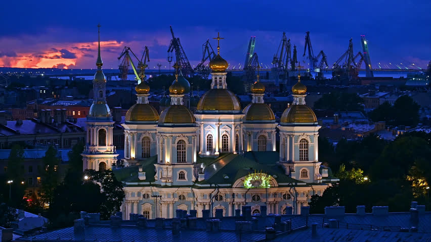 Saint-Petersburg, Russia city center - Saint-Nicholas Naval Cathedral - russian christian church in night time, rooftop view. Cathedral lit, surrounding buildings in cold blue tones
