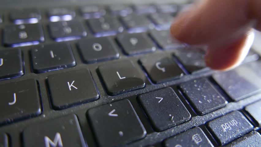 POV of someone typing on a laptop. A person typing on a computer keyboard. A close-up of a laptop keyboard. Computer keys. A dirty keyboard.